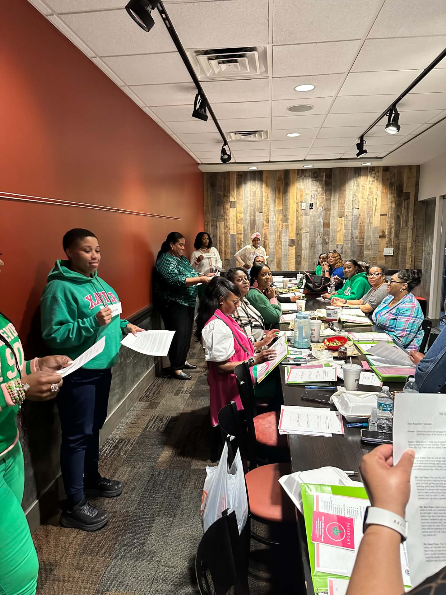 Sorors gathered around a table with chapter materials